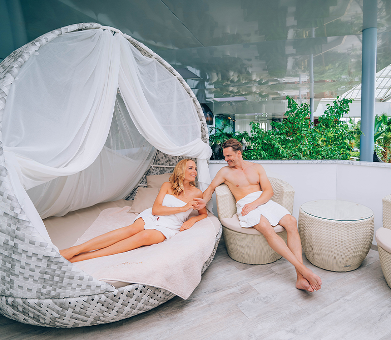A couple is enjoying some downtime in their idyllic island suite.