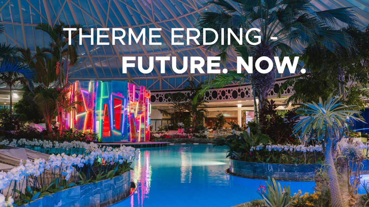 Nachtaufnahme der Therme Erding mit der bunt beleuchteten Re-flexion Sauna in der Mitte.