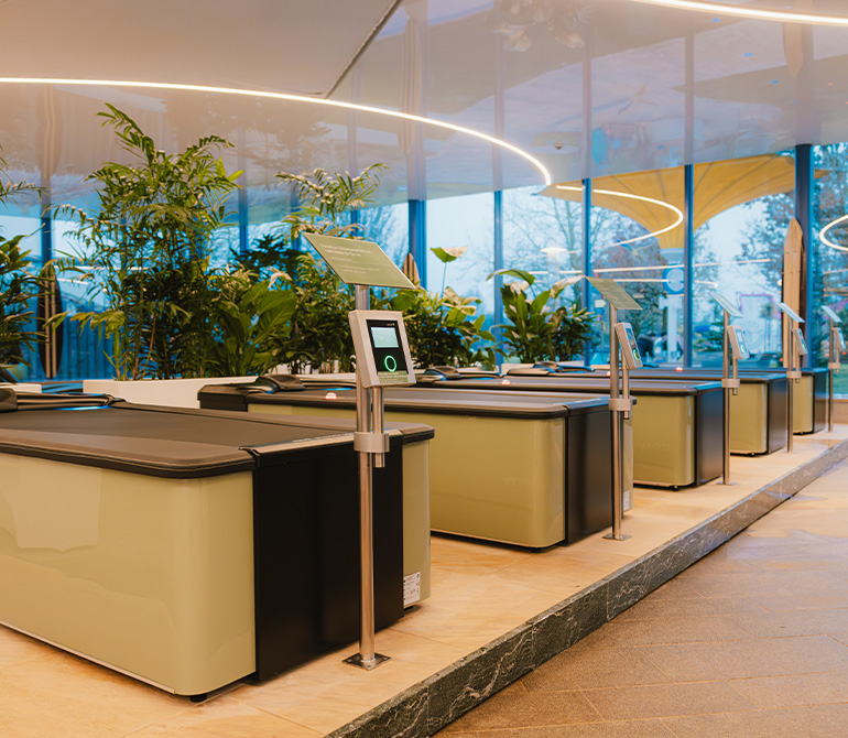 Large above-water massage tables, with plants visible in the background.
