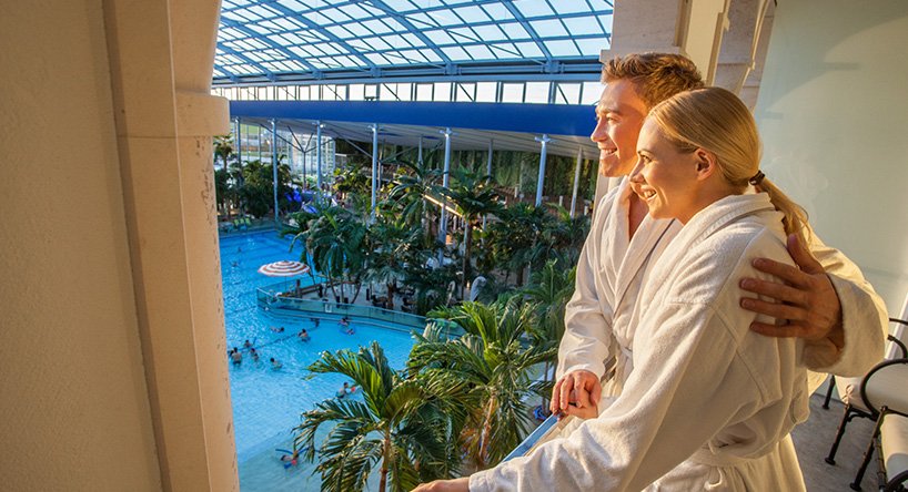 Balcony of the Serenissima room with a view of a pool and palm trees